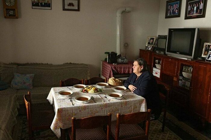 An Old Albanian Lady Dining With Her Dead Husband & Children Who Were Killed In 1999 During The War
