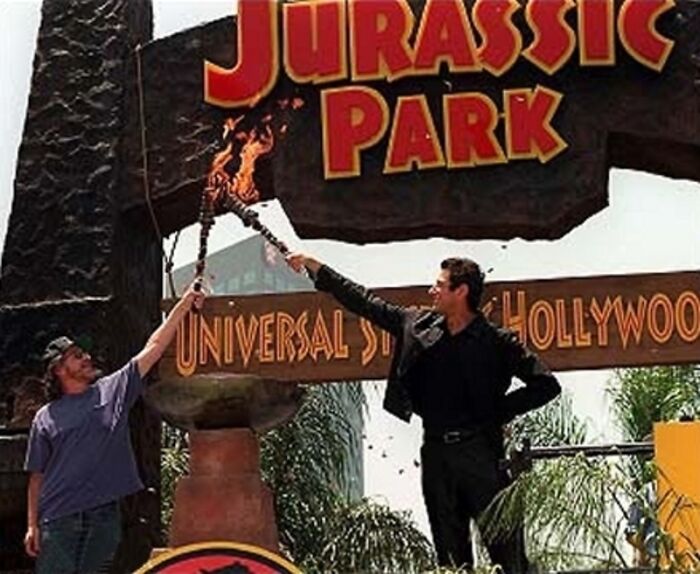 Jurassic Park: The Ride Officially Opened At Universal Studios Hollywood. Here, Steven Spielberg And Jeff Goldblum Lift The Torches For The Ride's Grand Opening On June 21, 1996