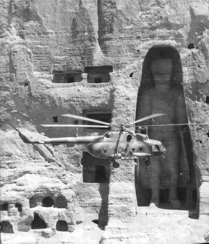 A Soviet Mi-8 Helicopter Flying Past One Of The Two Buddhas Of Bamiyan, Afghanistan 1980 