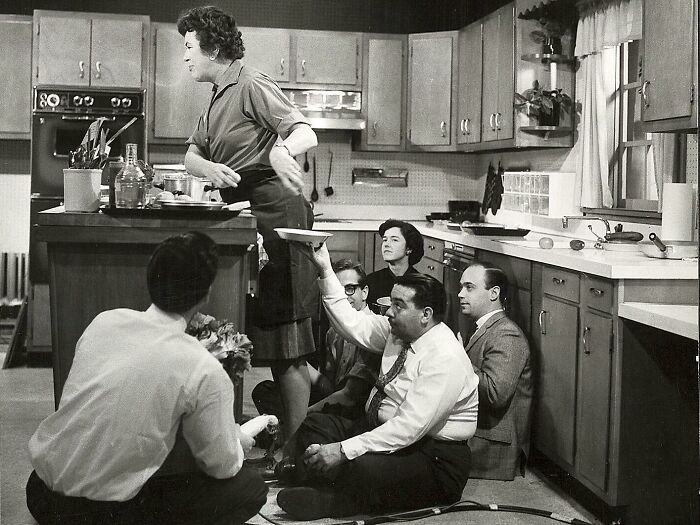 Historical photo of a kitchen scene with crew working behind the scenes, illustrating perspective on staging techniques.