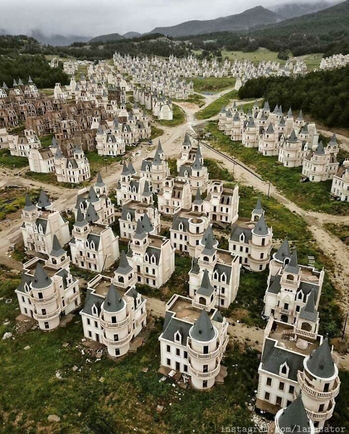 Abandoned, unfinished urban hell housing complex resembling a dystopian movie setting in a neglected landscape.