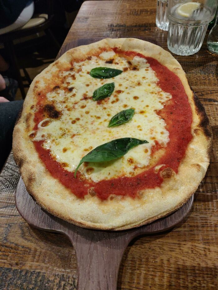 A Pizza On A Board That's Too Small. Cutting It Was A Challenge 