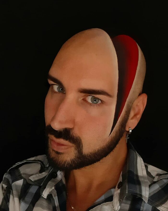 Italian artist using his head as a canvas with painted optical illusions creating a striking visual effect on his face.