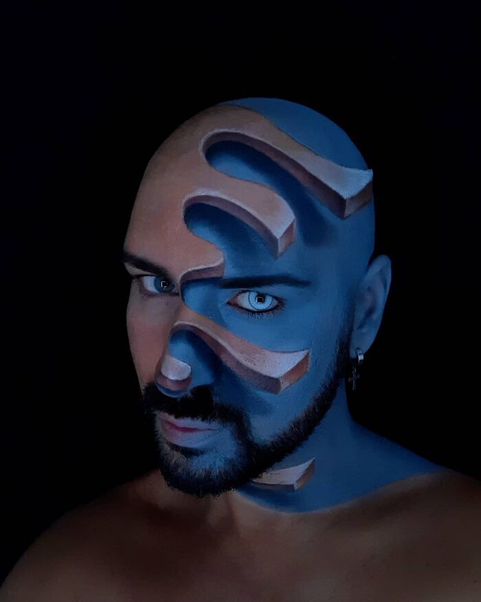 Italian artist's face painted with body art creating convincing optical illusions of depth and cutouts on skin.