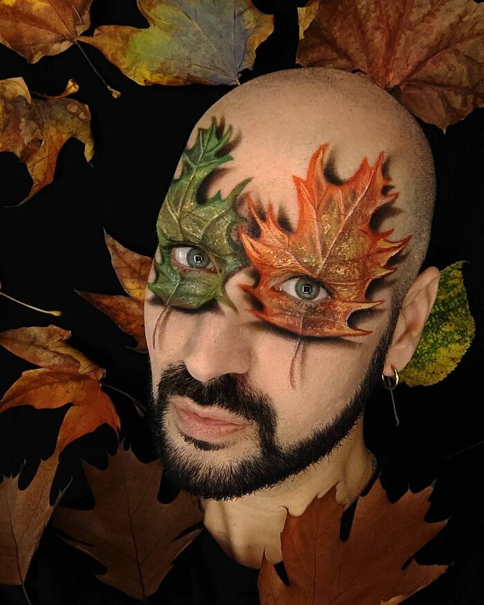Italian artist uses his body as a canvas with painted autumn leaves creating convincing optical illusions around his eyes.