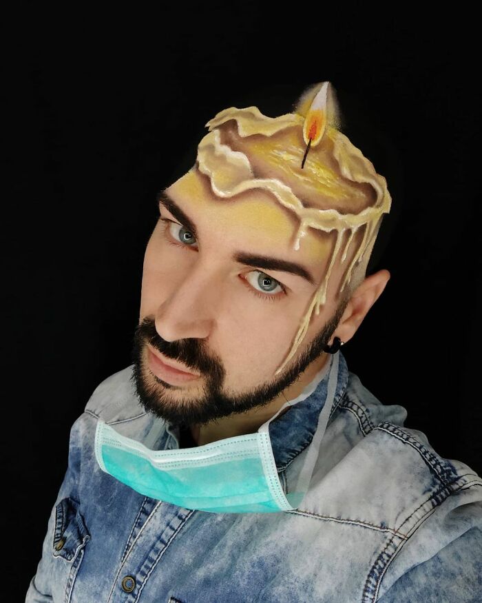 Italian artist using his body as a canvas to create a realistic candle optical illusion on his shaved head.