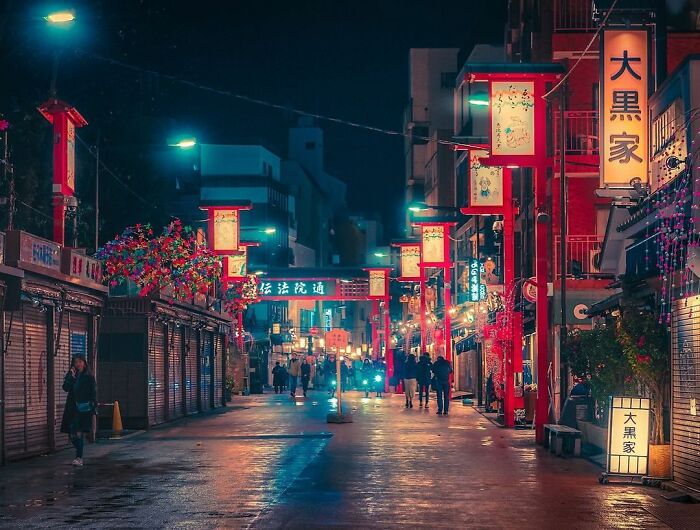 Night street scene in Japan illuminated by colorful lanterns, capturing the beauty of Japan in a vibrant urban setting.