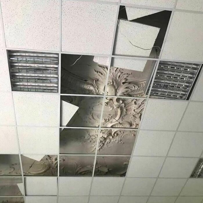 Broken ceiling tiles revealing ornate decorative plasterwork, showcasing one of the weirdest Instagram account photos.