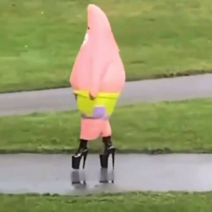 Person in a Patrick Star costume wearing high platform heels walking on a wet path, showcasing weird Instagram content.
