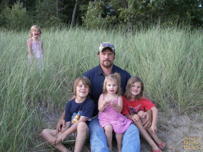 This Is My Husband And Four Children. We Asked The Kids To Sit Down With Dad To Get Their Pictures Together, But My Daughter Didn’t Want To Be In The Picture, So We Said, “Okay, Just Stay Over There.” I Started To Take The Picture And She Got Even More Upset For Being Left Out Of The Picture. As You Can See My Husband Was Also Annoyed!