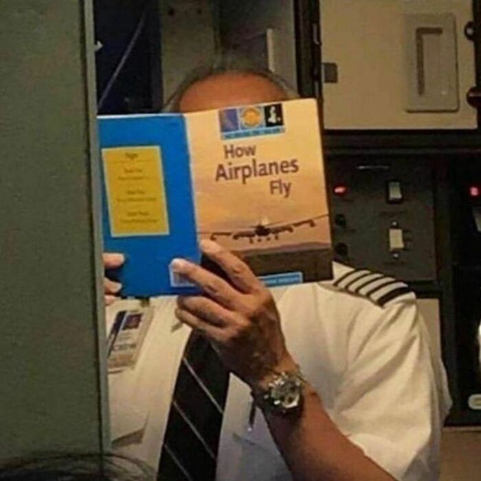 Pilot in uniform reading a book titled How Airplanes Fly, featured on a weird Instagram account post.