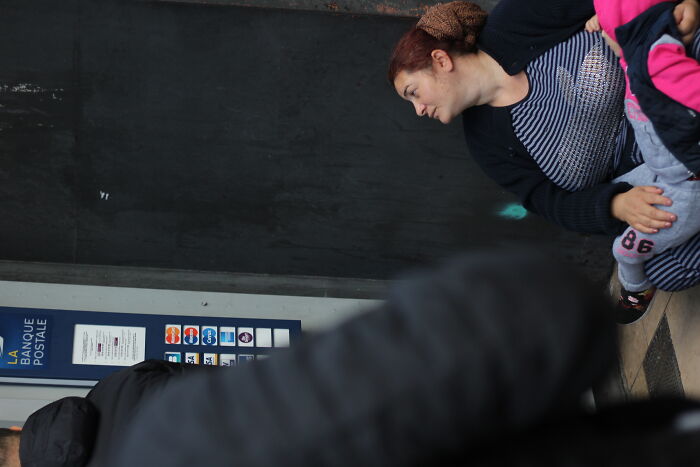 A Man Taking Money For The Woman With Her Child