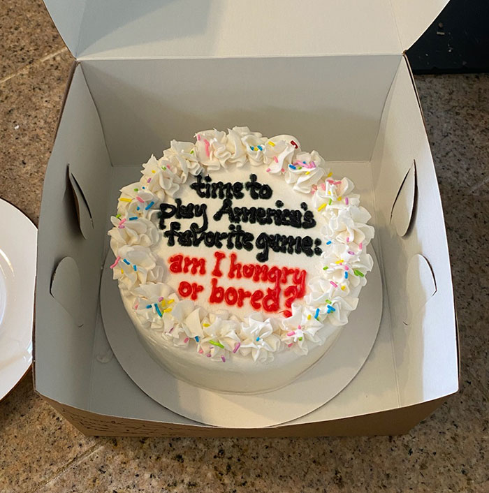 Funny cake with colorful sprinkles and humorous text, "Am I hungry or bored?" in a box.