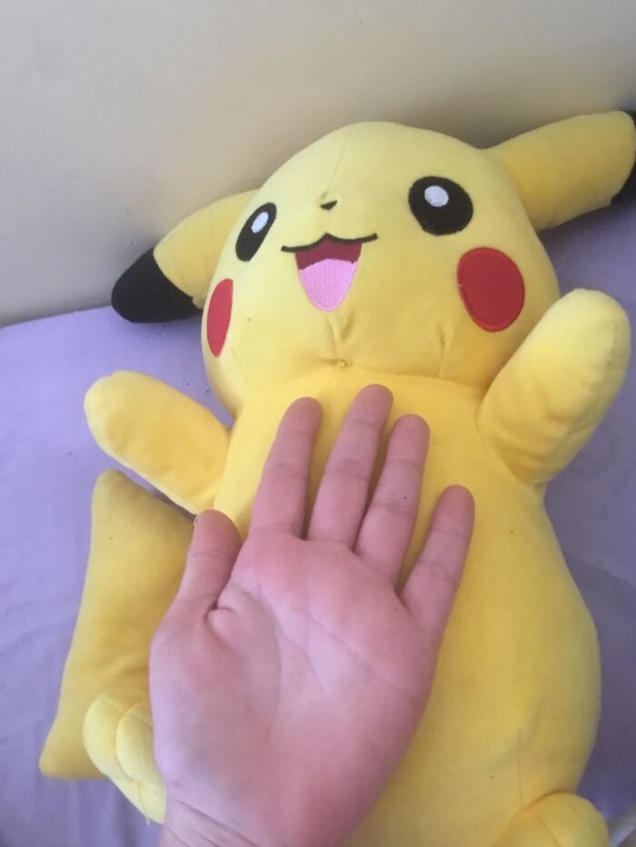 One Of My Favourite Things Is This Giant Pikachu With A Comparison To My 12-Year-Old Hand. I Got It From A Claw Machine.