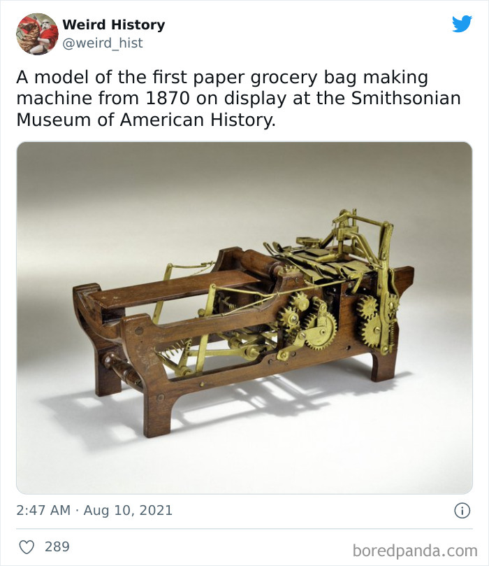 Model of the first paper grocery bag making machine from 1870 displayed at the Smithsonian, showing intricate gears and woodwork.