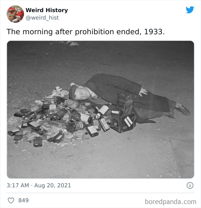 Man lying next to a pile of empty alcohol bottles, a weird history moment from the end of prohibition in 1933.