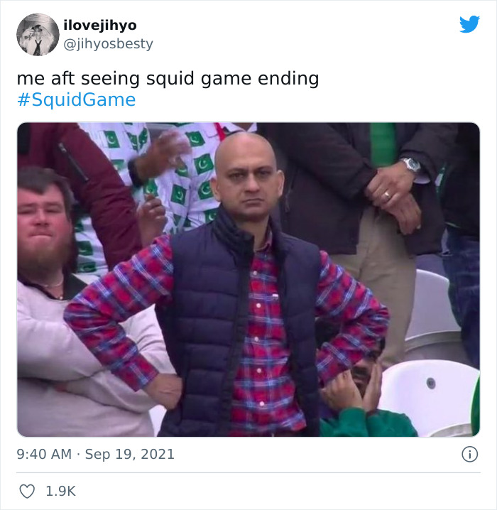 Person in a red checkered shirt and blue vest, hands on hips, reacting to the ending of Netflix's Squid Game.