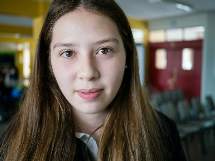 Young adult woman in a casual indoor setting, representing real world secrets shared for young adults entering it.
