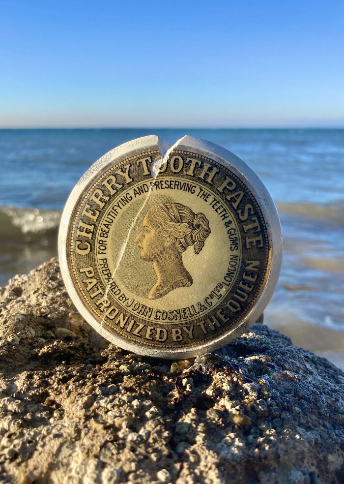 Antique cherry tooth paste tin found while searching for treasure that washes up on the beach by the ocean.