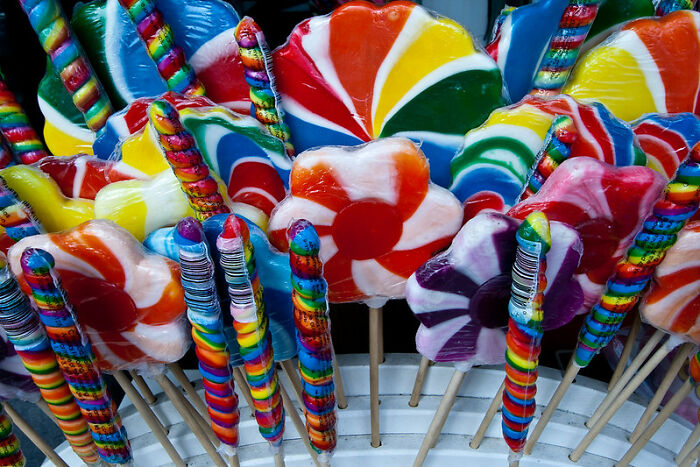 Colorful swirl and striped lollipops displayed on sticks, highlighting vibrant candy in an online group context discussing tactical nuke dodges.