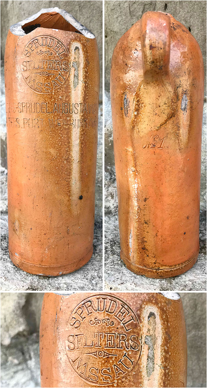 Antique ceramic bottle found while searching for treasure that washes up on the beach, showing weathered details and markings.