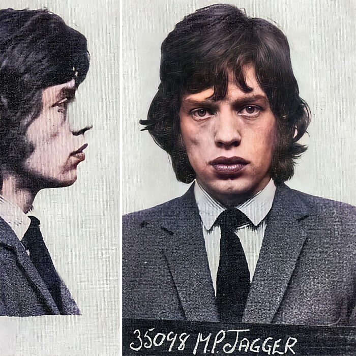 Vintage mugshot of famous person Mick Jagger, restored old photograph showing front and side profile in a suit and tie.