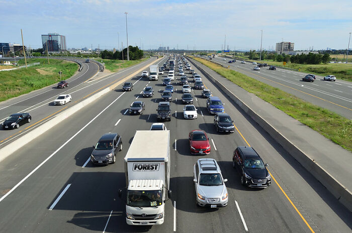 Heavy highway traffic with multiple lanes of cars and trucks representing the concept of dodging a huge tactical nuke.