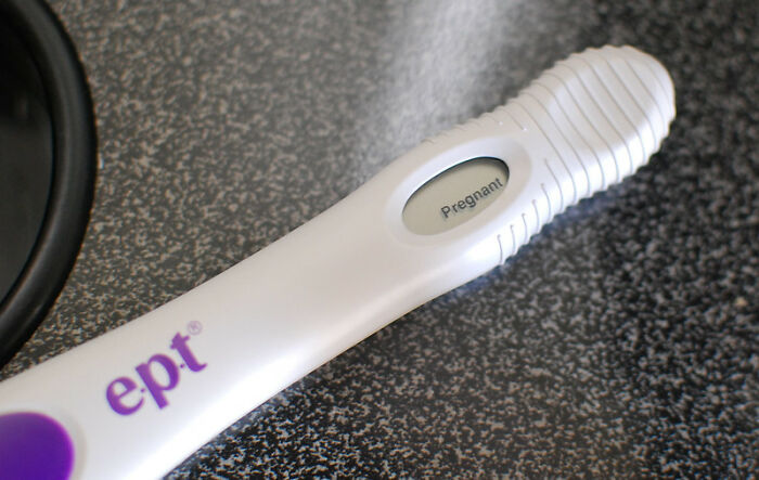 Digital pregnancy test showing positive result on a kitchen countertop, illustrating a huge tactical nuke dodged scenario.