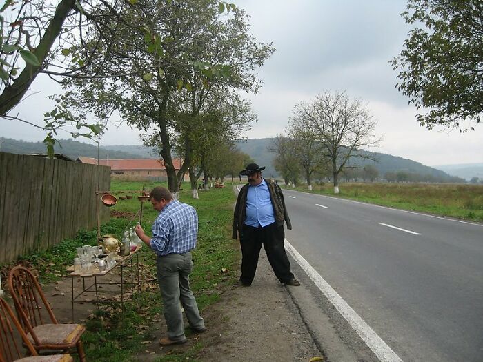 Two men by the roadside with vintage items, illustrating real world secrets shared in an online group for young adults.