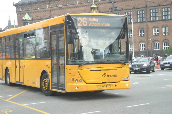 Yellow city bus on a busy street, symbolizing real world secrets shared to help young adults enter it.