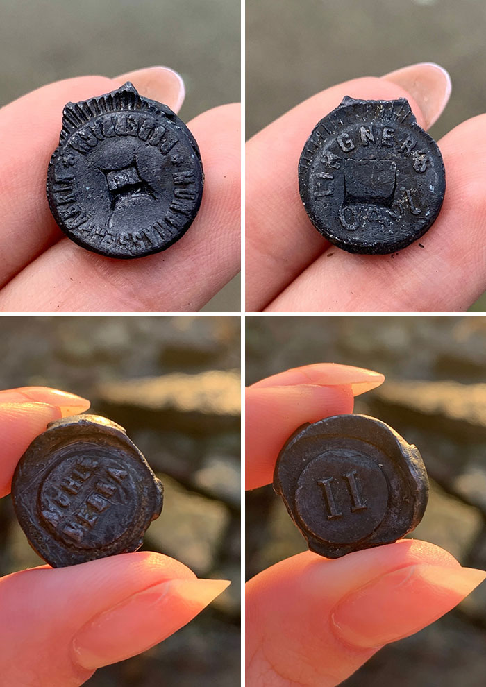 Close-up of antique objects found on the beach, held between fingers showcasing detailed textures and inscriptions.
