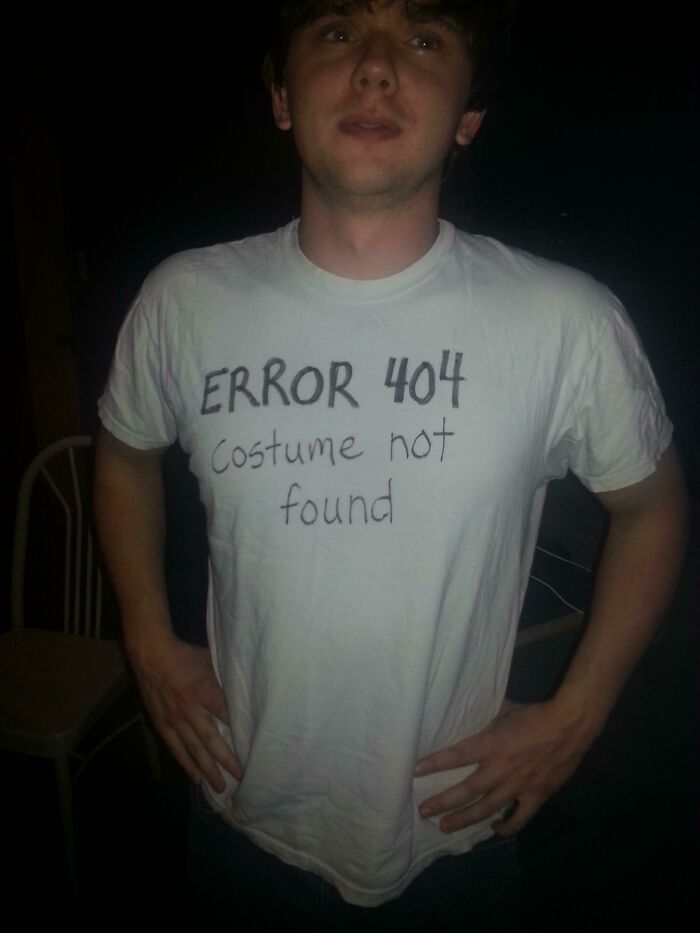 Man wearing a simple DIY Halloween costume shirt with Error 404 Costume not found text, showing effortless creativity.