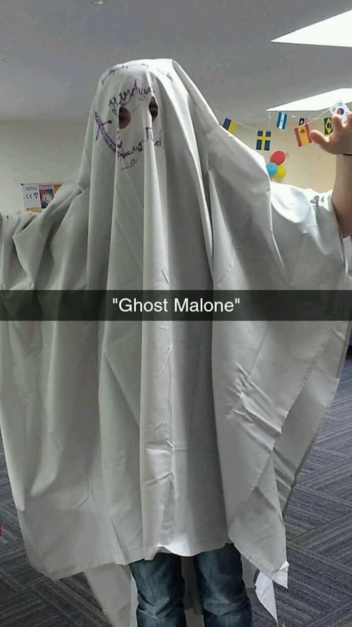 Person wearing a simple ghost costume made from a white sheet with holes for eyes, a creative Halloween costume idea.