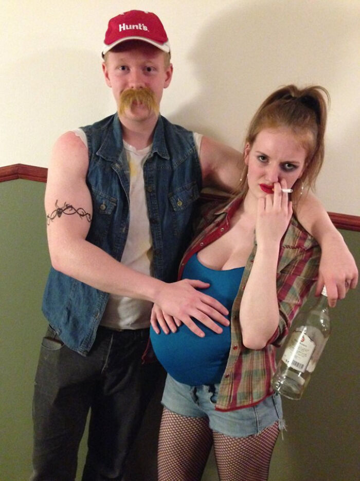 Couple in simple Halloween costumes with a fake pregnancy belly and casual clothes, showing great results with minimal effort.