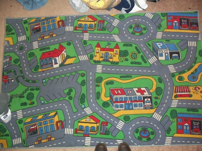 Children's play rug with colorful roads and buildings, a nostalgic item from the 2000s.