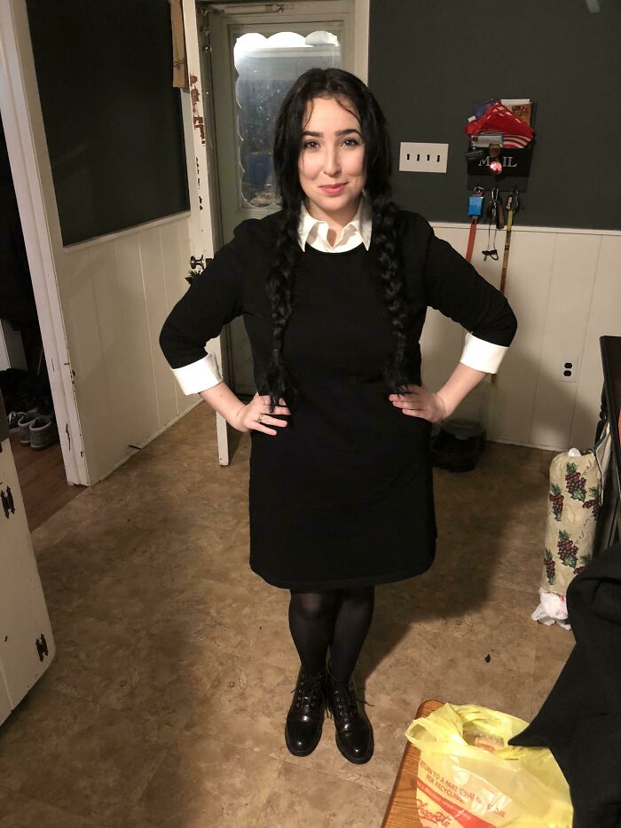 Woman in a simple Halloween costume with braided hair and black dress, showing an effortless yet great costume idea.