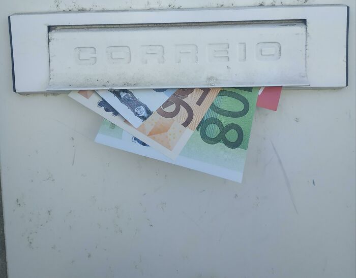 Mailbox with foreign currency partially visible inside the slot, illustrating evil marketing techniques involving money.