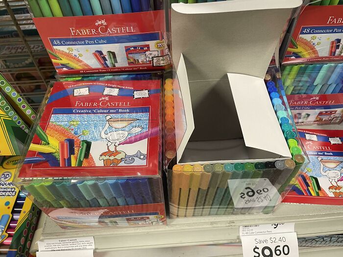 Set of colorful Faber-Castell markers and coloring books displayed on a store shelf with price tags visible.
