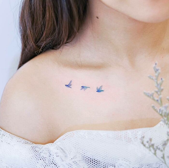 Small blue bird tattoo on shoulder, an interesting first tattoo idea.