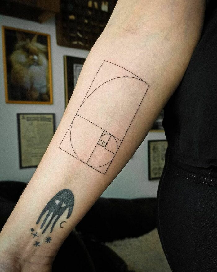 Geometric and abstract tattoos on a forearm, showcasing unique first tattoo ideas.