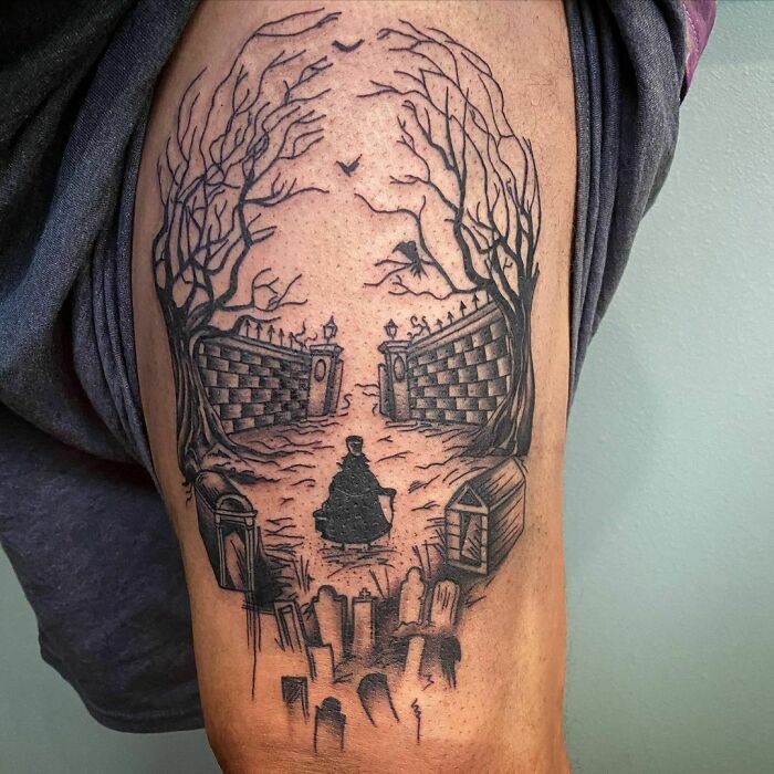 Spooky Halloween tattoo featuring eerie trees, gravestones, and a mysterious figure in black and white design.
