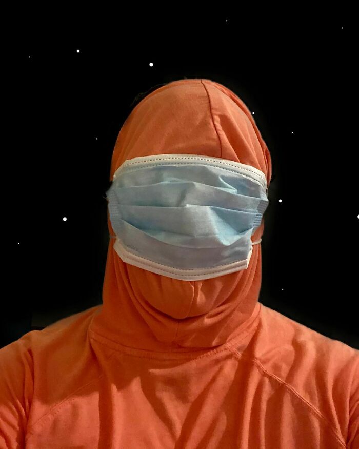 Person in a simple Halloween costume wearing an orange hoodie and a face mask, showing minimal effort and creativity.