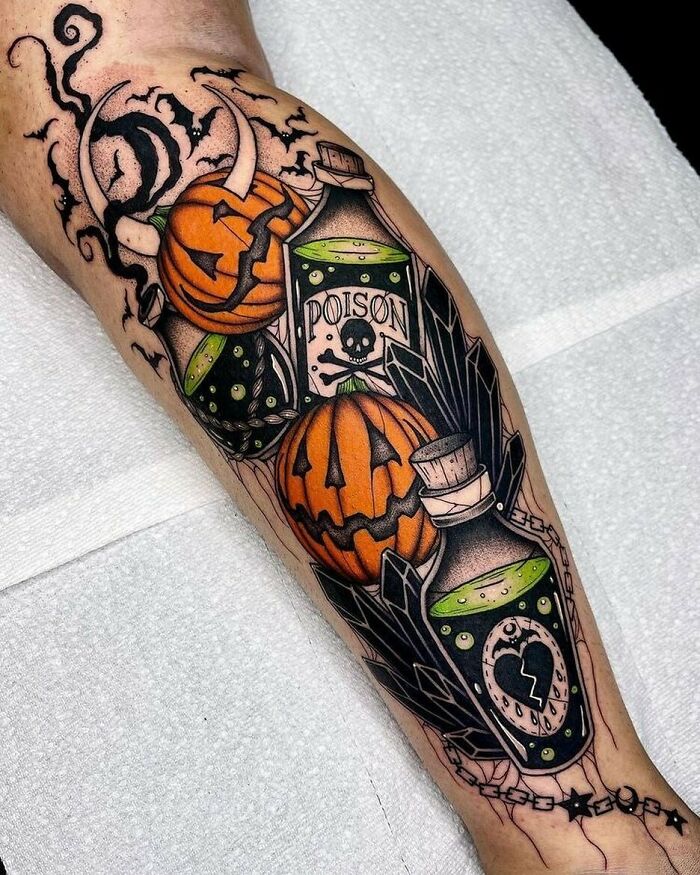 Spooky Halloween tattoo featuring jack-o'-lanterns and poison bottles on a person's leg, highlighting horror themes.