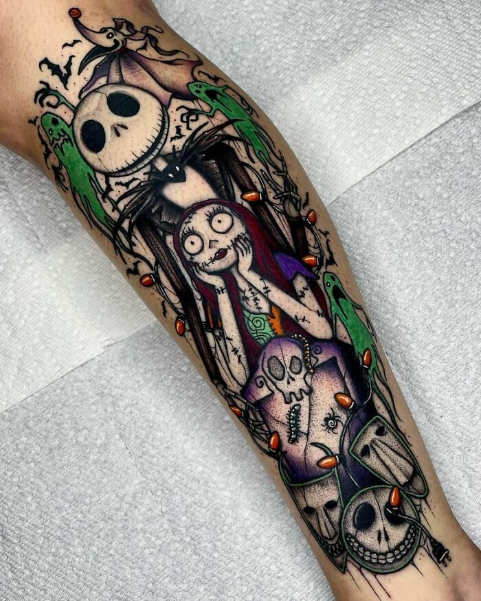 A vibrant spooky Halloween tattoo featuring iconic horror characters with colorful details and skull motifs.