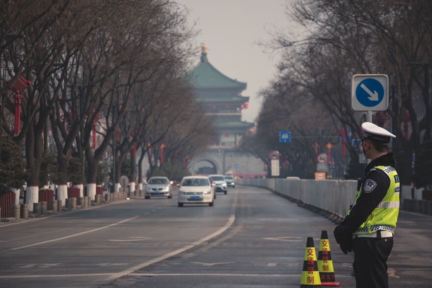 Policeman Checking If Drivers Have Permits To Be Out