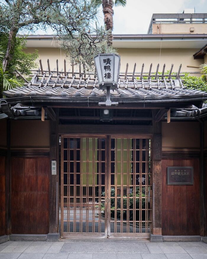 Traditional Japanese wooden architecture with a tiled roof and sliding lattice doors, showcasing old architecture in Japan.