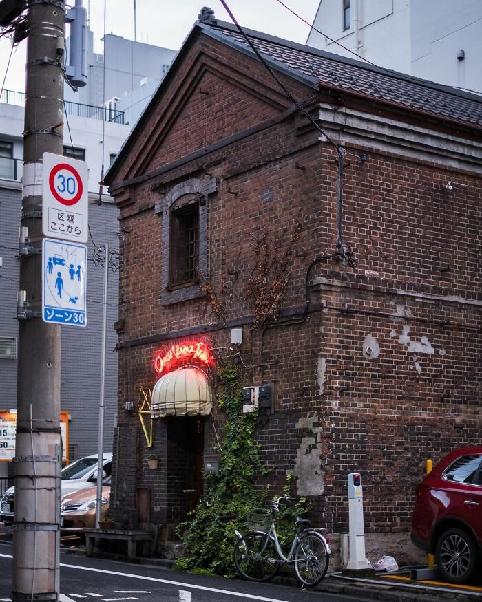 Old architecture in Japan shown by a weathered brick building blending traditional design in an urban setting.