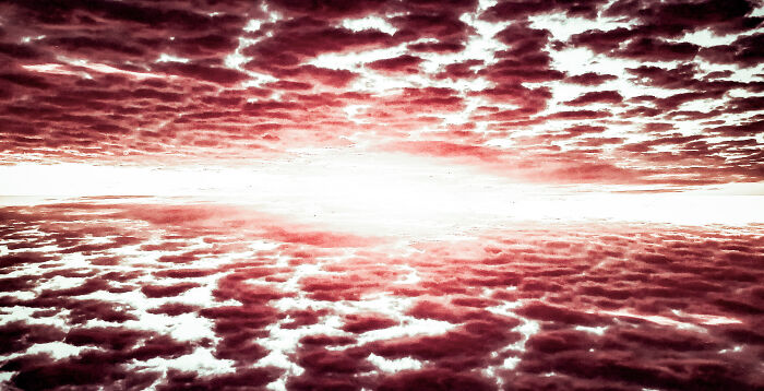 Dramatic weather in September with dense, textured clouds reflecting light over a vast horizon at sunset.