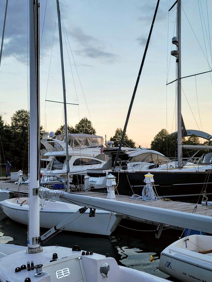 Sailboats docked at a marina during a calm September evening with clear skies and gentle weather conditions.