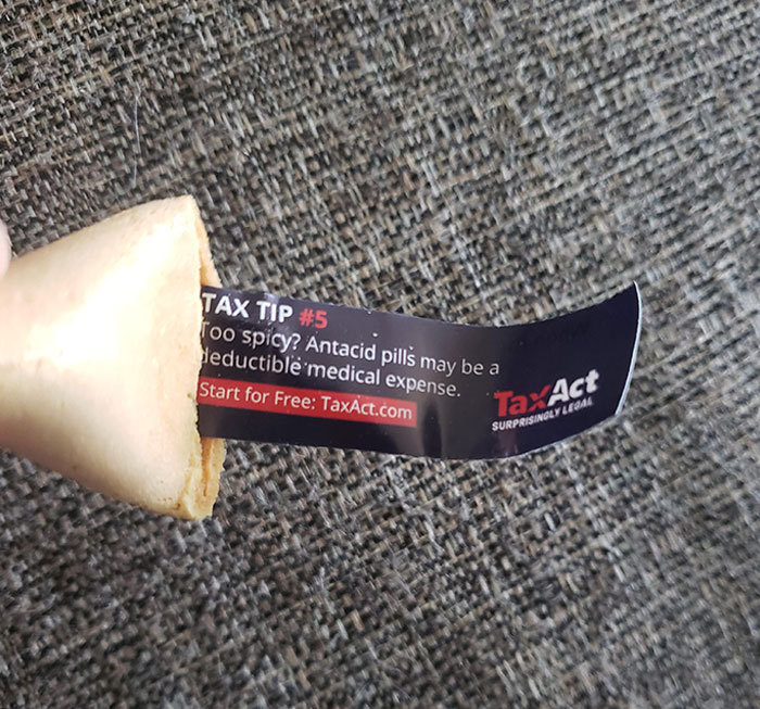 Fortune cookie with a hidden marketing message promoting TaxAct, illustrating evil marketing techniques used by businesses.